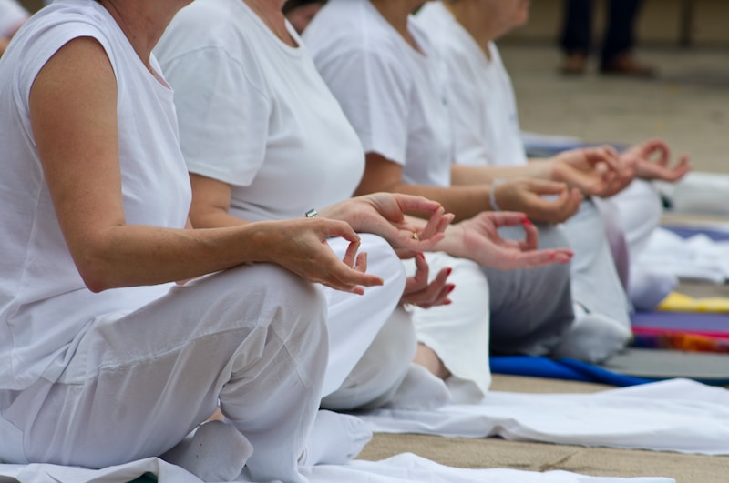 a group of people sitting on the ground doing yoga